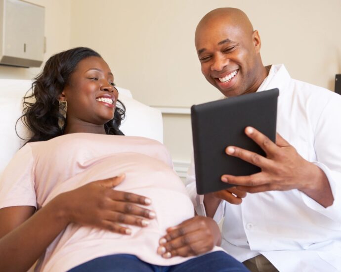 Couple looking at ipad in doctors office